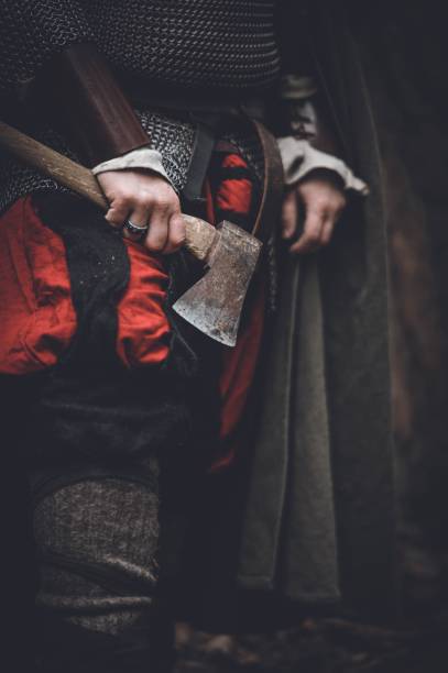 istock Man dressed in authentic medieval armor standing in the middle of forest 1498863681