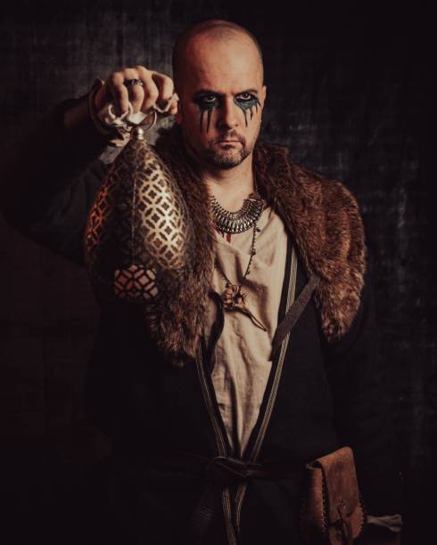 istock Man dressed in authentic medieval armor standing in the middle of forest 1498863690