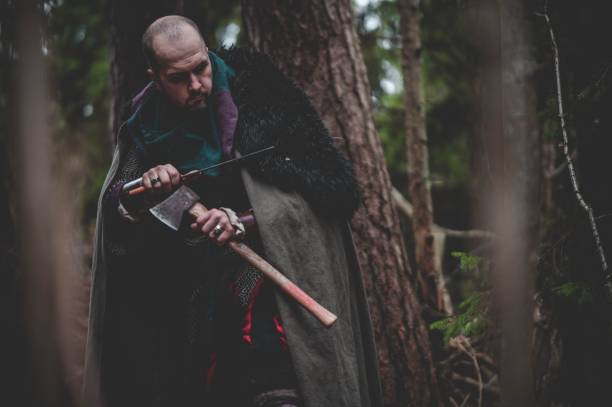 istock Man dressed in authentic medieval armor standing in the middle of forest 1498863706