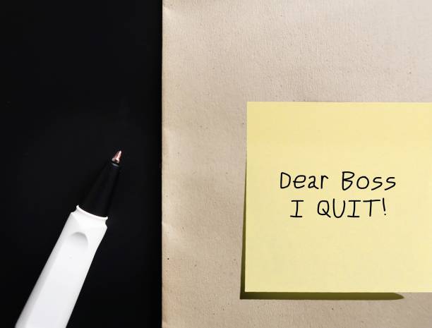istock Pen and office document envelope with handwritten text note DEAR BOSS I QUIT, concept of decision making to leave corporate job, the great resignation when employees voluntary leave their jobs for work life balance 1498864705