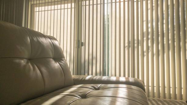 istock Soft brown sofa in an office against blinds on a sunny day 1498868393