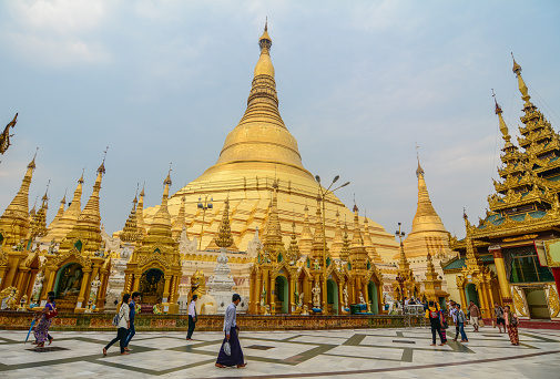 Yangon, Myanmar - Feb 26, 2016. People walking at Shwedagon Pagoda in Yangon, Myanmar. Shwedagon is known as the most sacred pagoda in Myanmar.