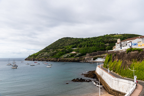 Angra do Heroismo, Portugal - July 2, 2022: Panoramic view of the old town, the beach and the port. Terceira Island, Azores. VIew at sunset