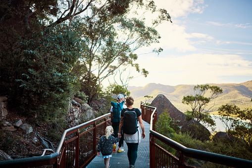 Young active family with a toddler bushwalking outside in the beautiful Freycinet National Park.