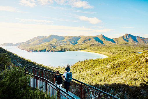 Young active family with a toddler bushwalking outside in the beautiful Freycinet National Park.