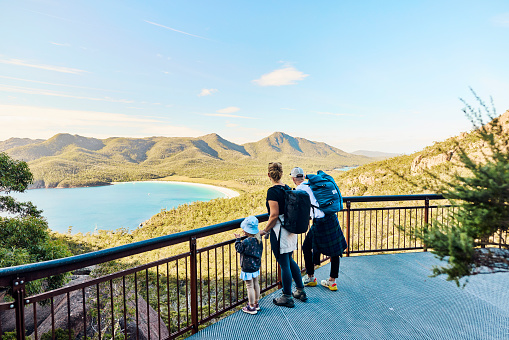 Young active family with a toddler bushwalking outside in the beautiful Freycinet National Park.