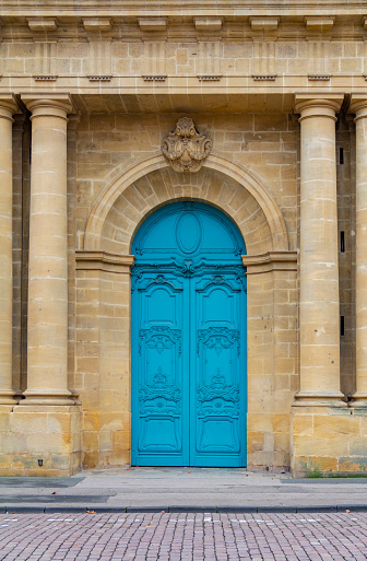 Blue ornamented door at a historic building seen in Metz, a city in the Lorraine region in France