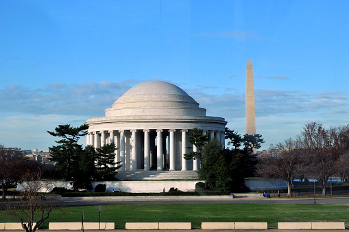 Washing D.C. USA- November 29, 2011: Washington is the great capital of a great nation in the world. There are so many gorgeous public buildings around the area of National Mall. Here is the Jefferson Memorial in the background of Washington Menument.