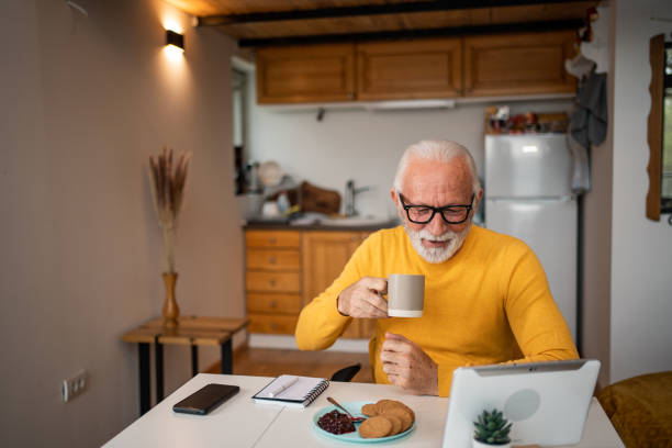 istock Senior man, pensioner, manages household budget with digital tablet and diary 1498873470
