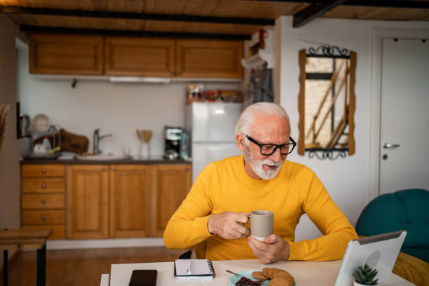 istock Senior man, pensioner, manages household budget with digital tablet and diary 1498874081