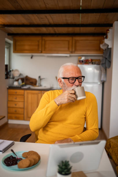 istock Senior man, pensioner, manages household budget with digital tablet and diary 1498874089