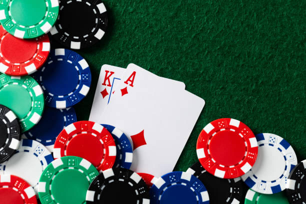 istock Playing cards and gambling chip on the table 1498875957