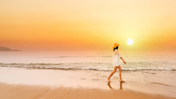 istock Woman walking at the beach 1498876376