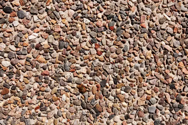 small stones in concrete wall as texture