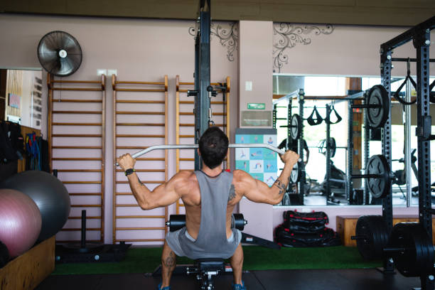 istock Strong man doing weights with a bar in a gym 1498877834
