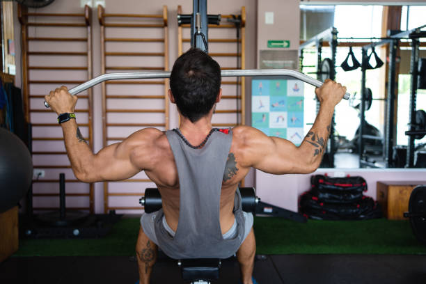 istock Strong man doing weights with a bar in a gym 1498877835