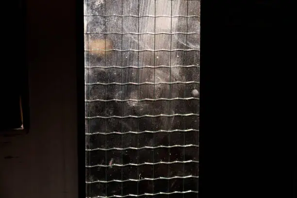 glass pane with protective metal wires in a mesh