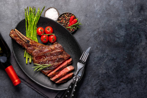 istock Medium rare grilled Tomahawk beef steak with asparagus 1498879787