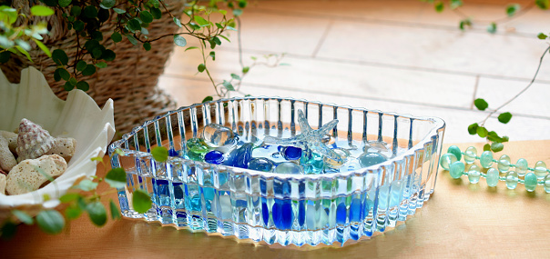 Round glass aquarium in the shape of a cognac glass with a blue betta fish. View from above