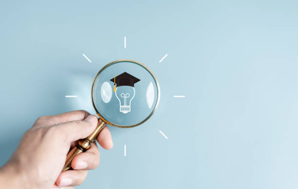 istock Hand holding magnifier with lightbulb graduation hat inside, Education course degree concept, Internet education course degree, study knowledge to creative thinking idea and problem solving solution. 1498881271