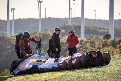 16 may 2023 - Igualada, Spain: group of paragliders ready to fly in the mountain