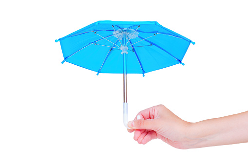 Close-up view of an open blue toy umbrella in hand isolated on white background.