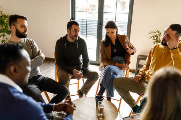 istock Diverse group of people discussing emotions and feeling during a therapy session 1498883761
