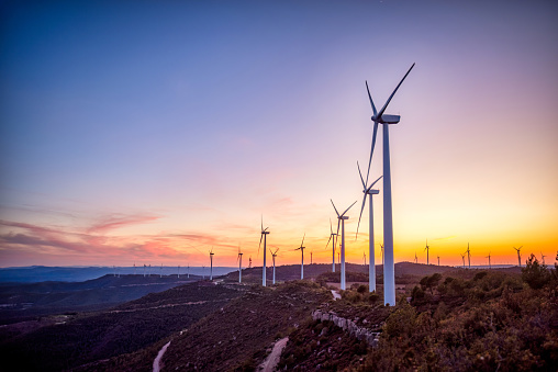 Renewable energy with wind turbines on the mountain at sunset. Maioles, Catalonia, Spain