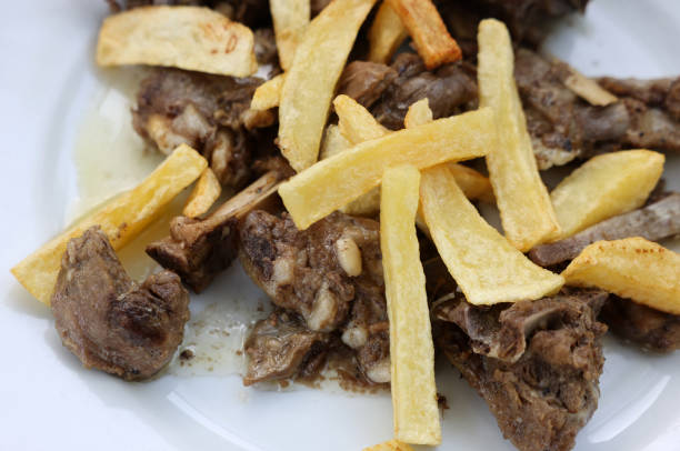 istock grilled goat with fries on a white plate 1498884913