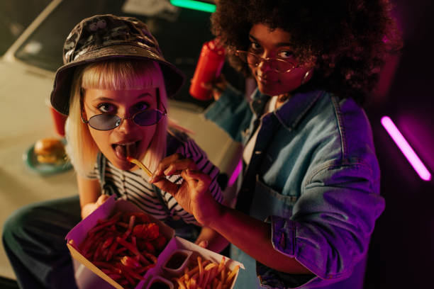 istock Cool friends eating fries outside. 1498886703