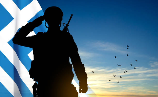 istock Silhouette of a saluting soldier with Greece flag against the sunset sky 1498888767