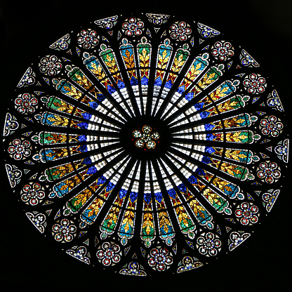Strasbourg, Alsace: Rosette stained glass window by the interior of famous Notre Dame Cathedral de Strasbourg. Gothic building, dating from the 1200s. UNESCO World Heritage Site.