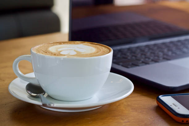 istock Coffee cup hot and laptop in cafe 1498894920