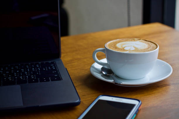 istock Coffee cup hot and laptop in cafe 1498894928