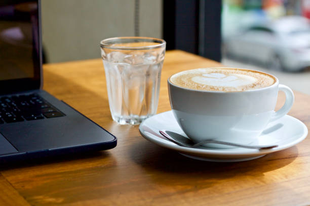 istock Coffee cup hot and laptop in cafe 1498894933