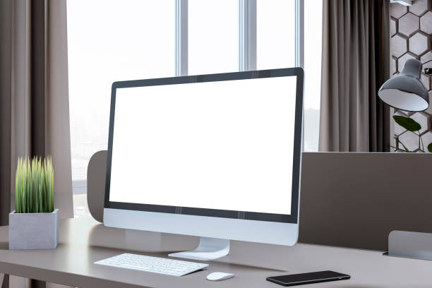 istock Close up of creative designer office interior with wall, empty white computer monitor and other items. Mock up, 3D Rendering. 1498896133
