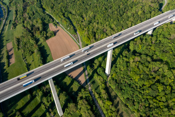 istock Aerial view of trucks on highway bridge 1498896414