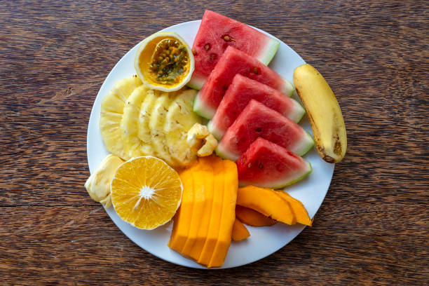 istock Tropical fruits on a breakfast plate, close up, top view 1498897715
