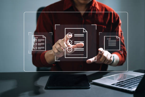 istock E-document management Paperless workplace, e-signing, electronic signature, document management. businessman signs an electronic document on a virtual notebook screen using a stylus pencil. 1498900526