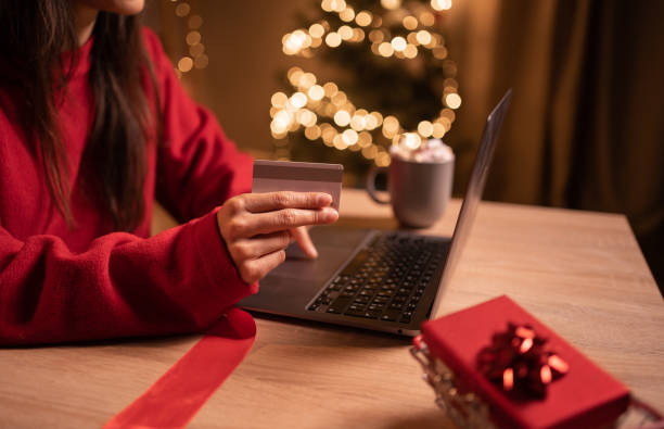 istock Shopping online during holidays. Woman using laptop computer and credit card, ordering Christmas gifts, close-up. Shopping, internet banking, store online, payment, holidays 1498902000