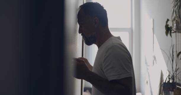 istock Depressed man in the hall. Resting against wall 1498902217