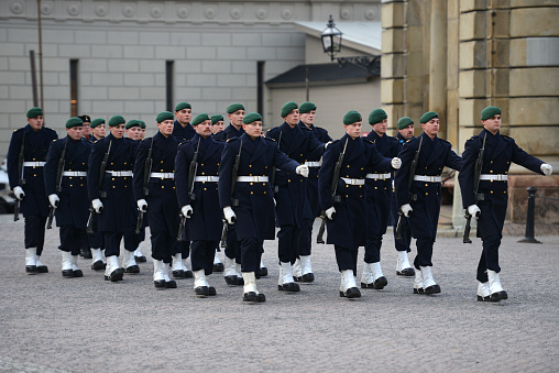 Group of Royal Guards outside the Stockholm Palace performing a guard rotation, on a sunny day in Stockholm, Sweden
