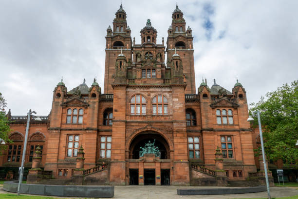 Glasgow, Scotland - People enjoying sunny weather outside the main entrance to the Kelvingrove Art Gallery and Museum.