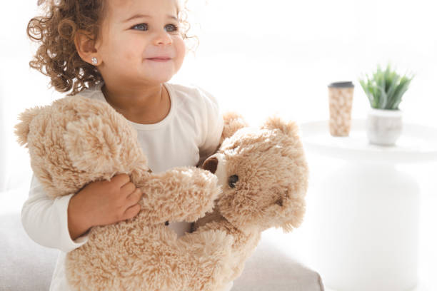 istock Little Girl Playing With Teddy Bear 1498905959