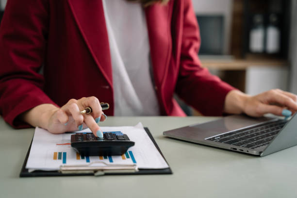 istock Women are using calculators to calculate office income. 1498907466
