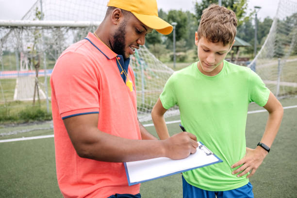 istock Boy having individual soccer training by the black coach 1498912887