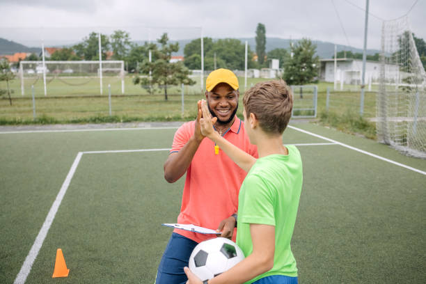 istock Boy having individual soccer training by the black coach 1498912890