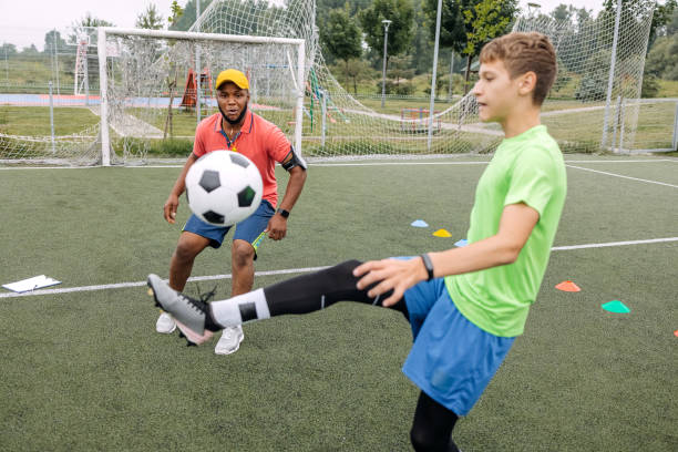 istock Boy having individual soccer training by the black coach 1498913398