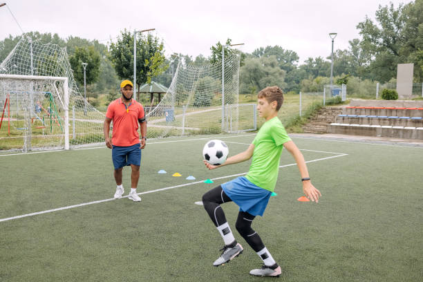 istock Boy having individual soccer training by the black coach 1498913458