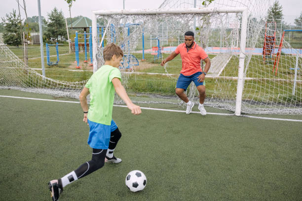 istock Boy having individual soccer training by the black coach 1498914236